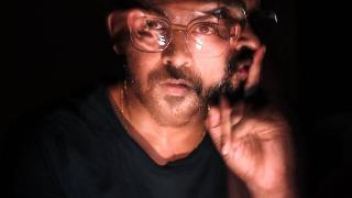 blurry photo of man with glasses