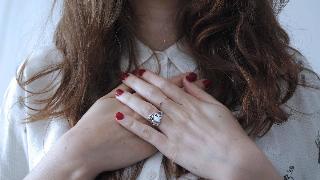 woman puts her hand on her heart 