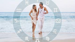 couple on the beach with astrological signs