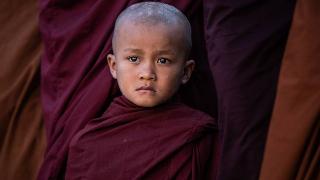 Buddhist novice monk lining up to receive alms and money donated by Buddhist devotees during Ananda pagoda festival in Bagan, Myanmar on January 9, 2020. Ananda pagoda festival is an annual celebration and held on the full moon day of Pyatho according to the Myanmar lunar calendar. Buddhist devotees offer alms and money to hundreds of Buddhist monks and novices, lining up in the pagoda compound. The tradition have been practised since the beginning of Bagan period.