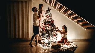 family-decorating-their-christmas-tree-