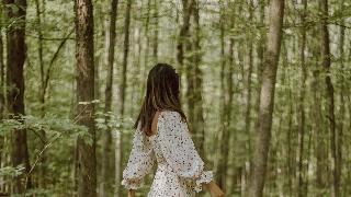 stylish-woman-strolling-in-green-forest