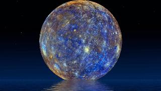 The planet Mercury hung in the sky above a body of water in which you can see its reflection.