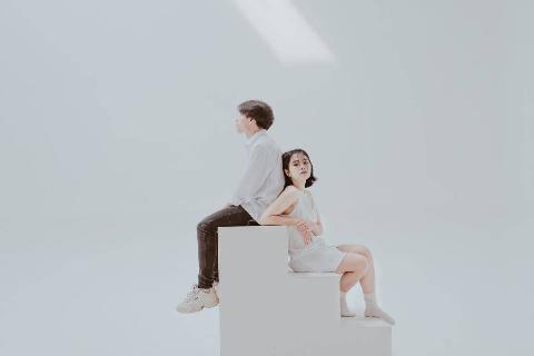 photo-of-woman-sitting-on-staircase-beside-man