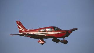 Red Piper PA-28 Cherokee flying enroute.