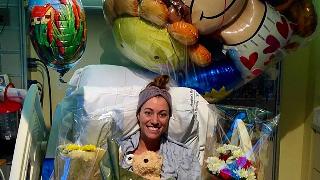 Brittany Williams when she was recovering in the hospital, surrounded by flowers and balloons. 