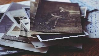 A stack of old, vintage photographs.