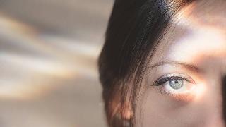 A closeup of a woman's eye in bright light.