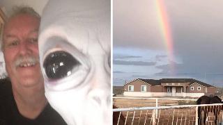 John posing with a large alien figure. | A rainbow shining above Stardust Ranch.