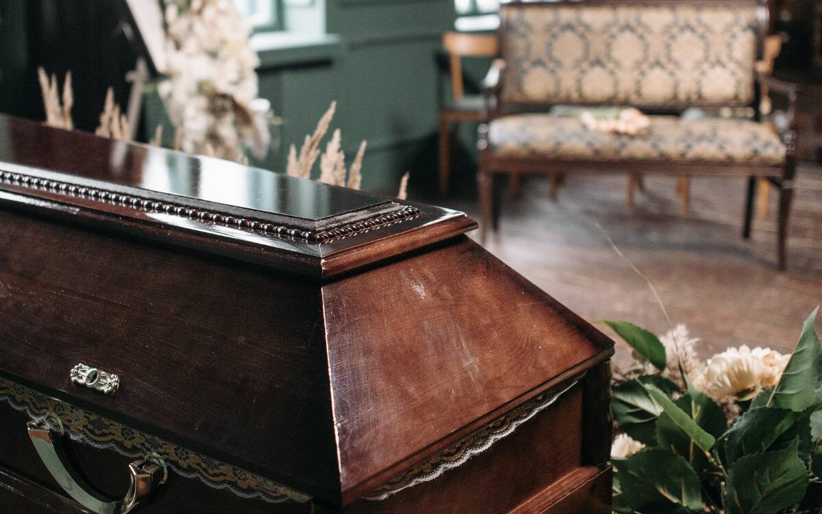 A photo of a coffin in a funeral parlor.