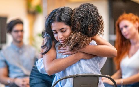 Two friends hugging close.