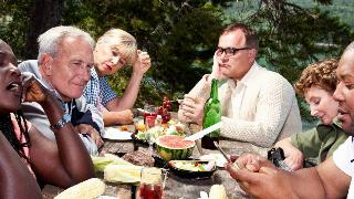 A family dinner in which people are looking bored, distracted, and annoyed.