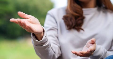 A close shot of a woman's hands gesturing as she speaks.