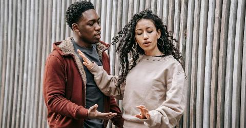 A woman rejecting a man trying to speak to her.