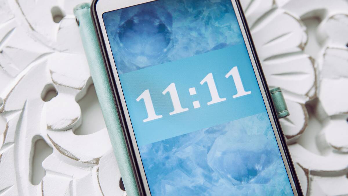 A close shot of someone's phone displaying the time 11:11.