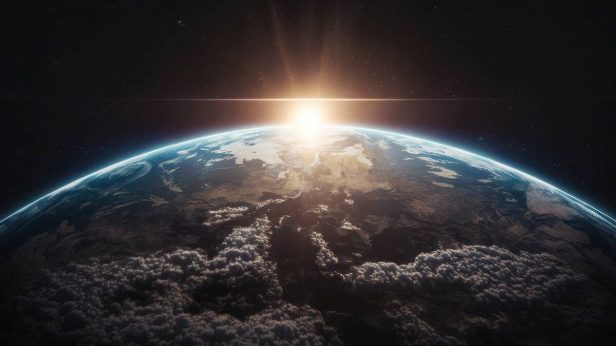 A render of the light of the rising sun cresting Earth's surface in space.