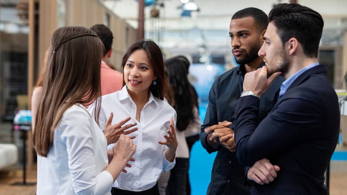 A group of professionals talking to each other at a networking event.