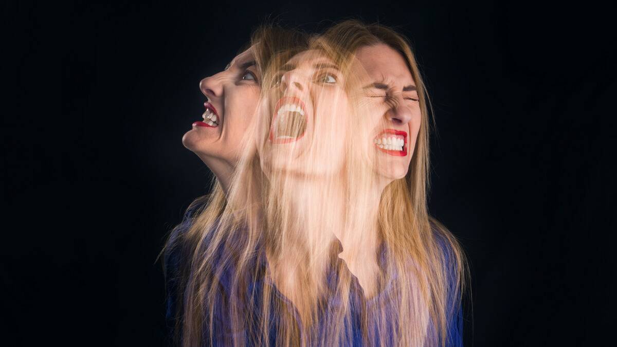 Three photos of a woman all semi-transpared and superimposed at different angles, each showing her in different stages or expressions of anger.