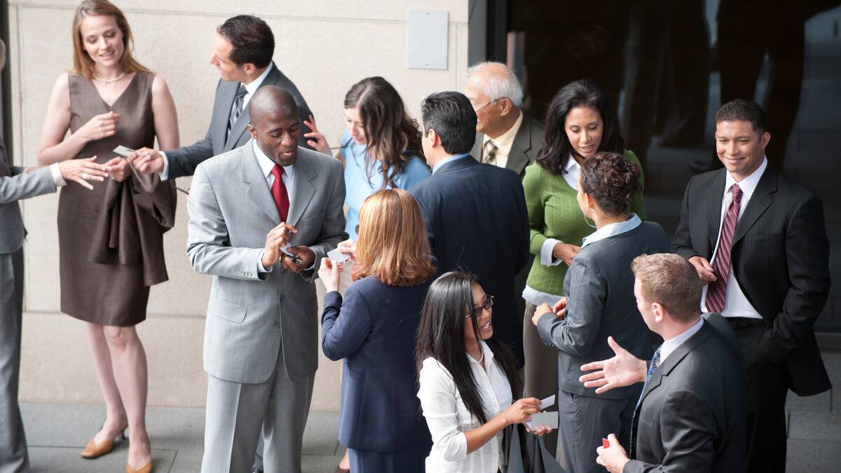 A group of people networking at a professional event.