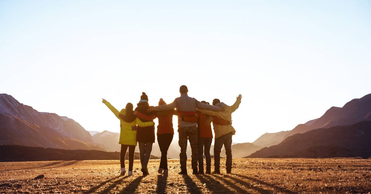 A group of friends holding each others shoulders.