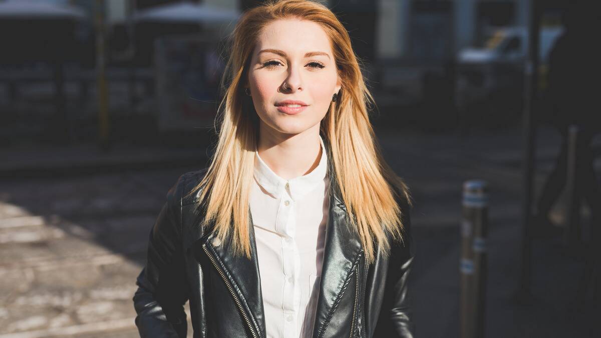 A young woman looking forward at the camera confidently.