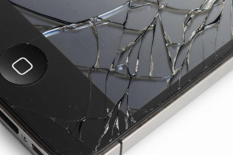 A closeup shot of a phone's cracked screen, namely the bottom right corner.