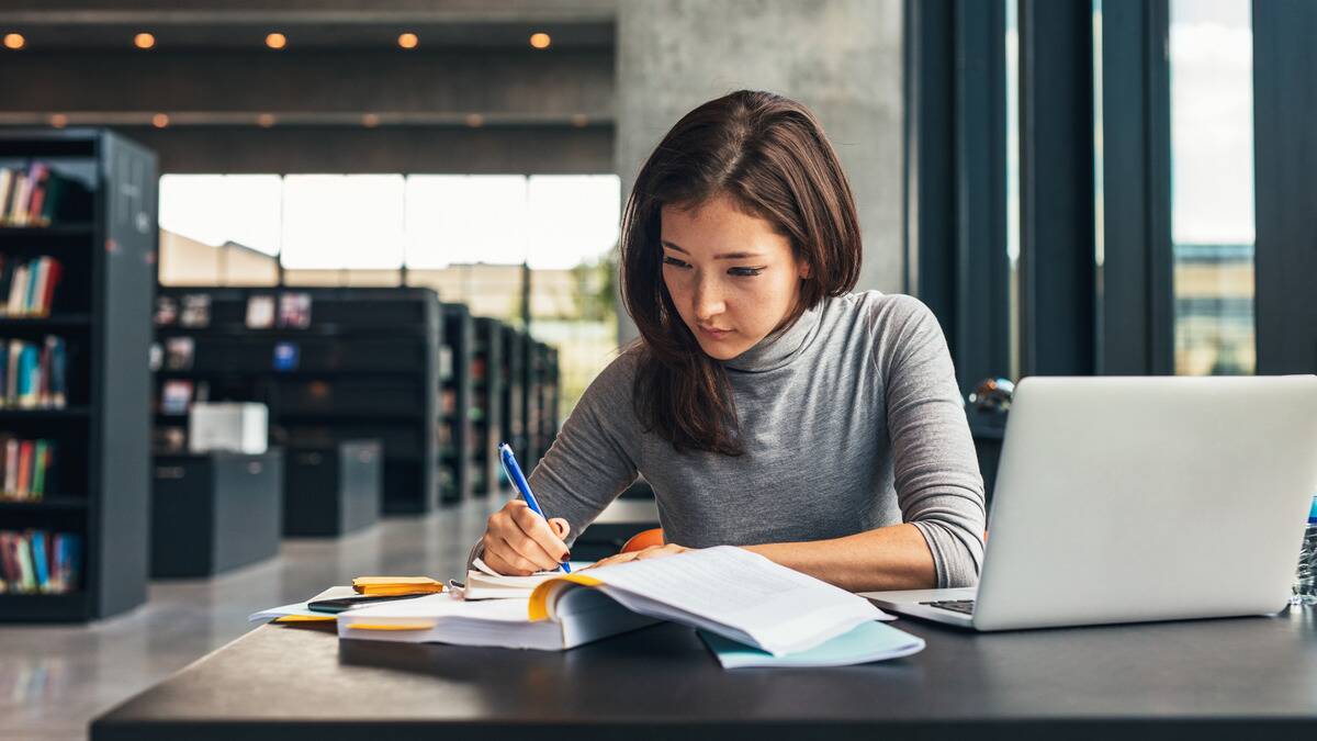 A woman studying in a library.