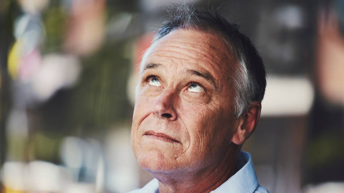 A close shot of a man rolling his eyes.