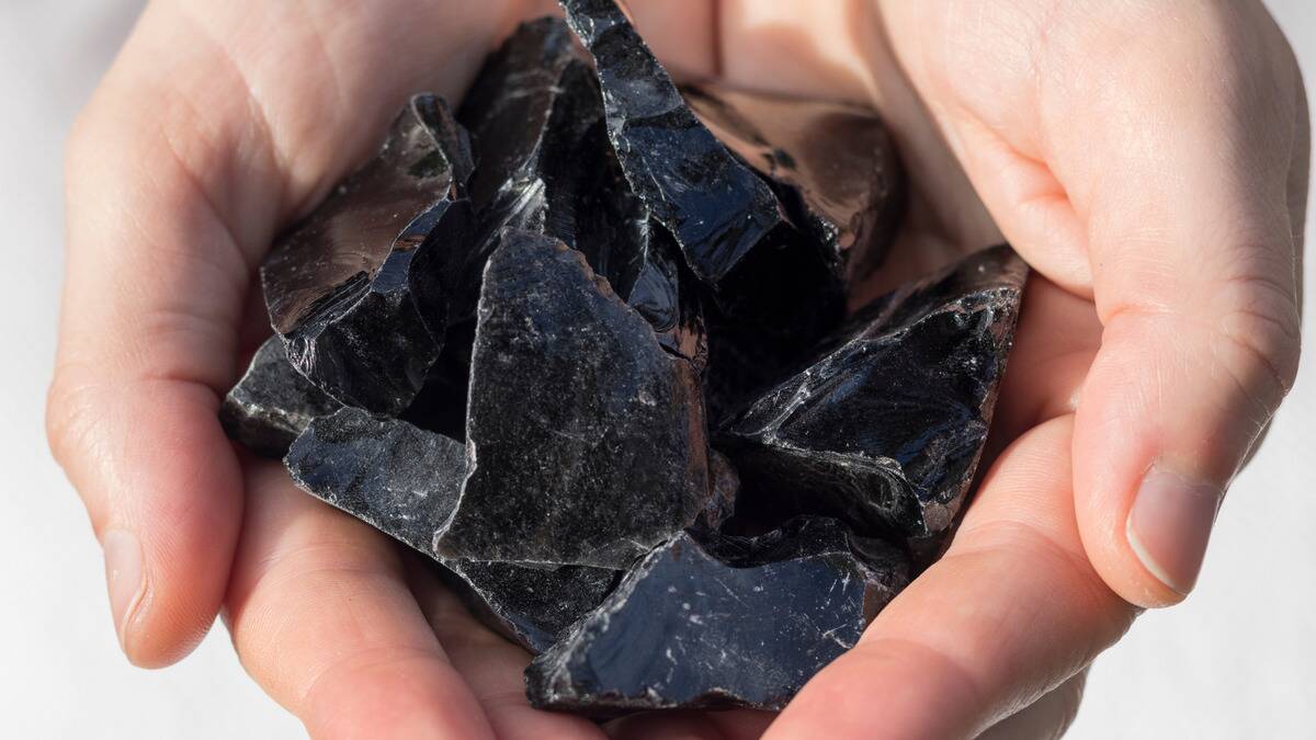 Someone holding a handful of obsidian chunks.