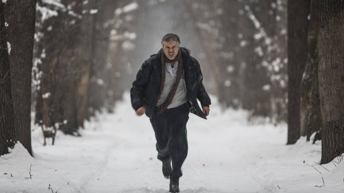 A man running toward the camera in the snow.