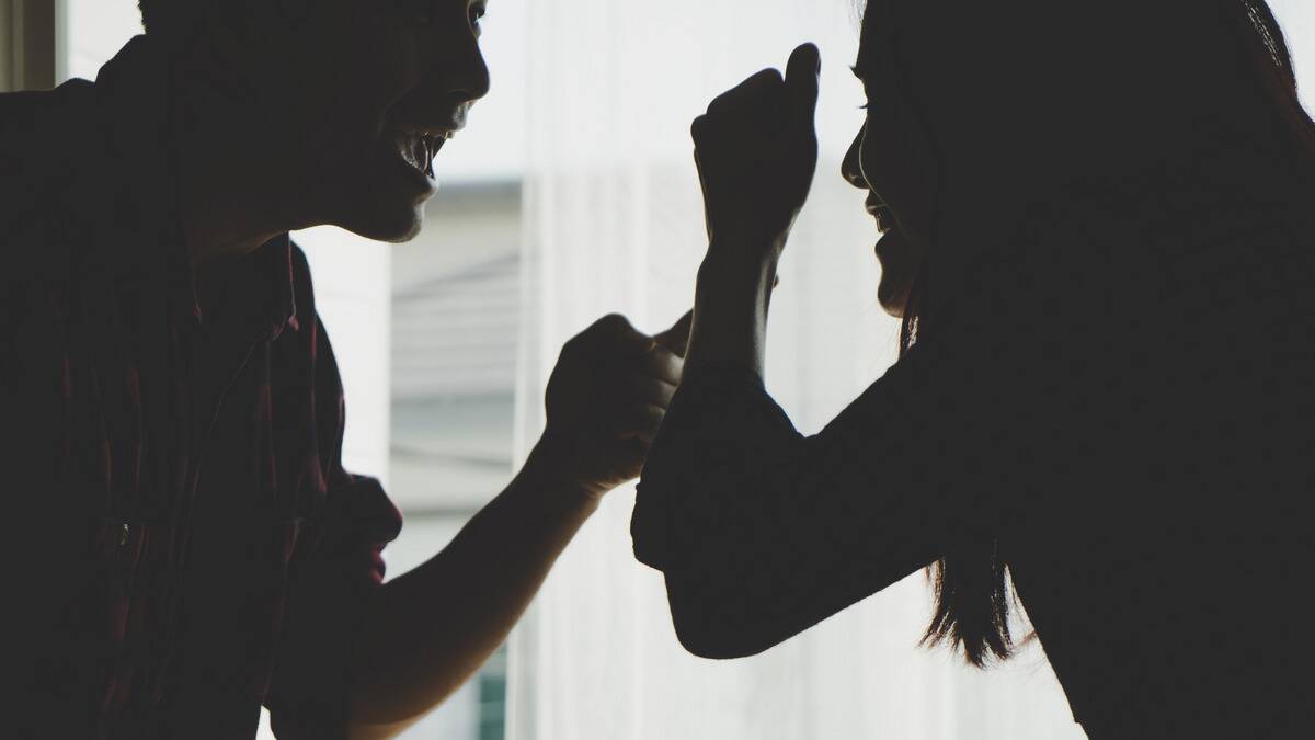 A close silhouette shot of a couple arguing.