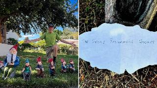 Blair posing with his gnomes, who are all placed in a line. He's on one knee with his arms spread behind them, smiling for the camera. | The gnome note with the society's name written on the back.