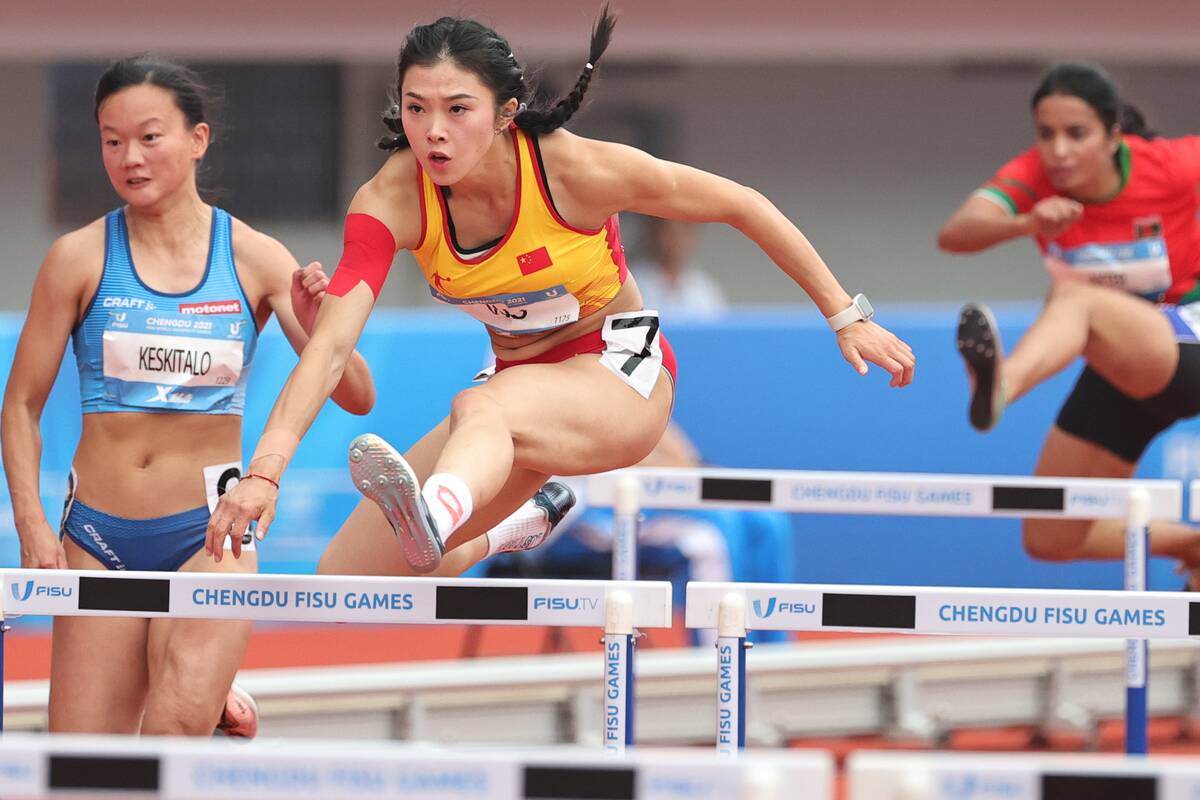 CHENGDU, CHINA - AUGUST 03: Wu Yanni (C) of Team China competes in the Athletics - Women's 100m Hurdles Heats on day 6 of 31st FISU Summer World University Games at Shuangliu Sports Centre Stadium on August 3, 2023 in Chengdu, Sichuan Province of China.