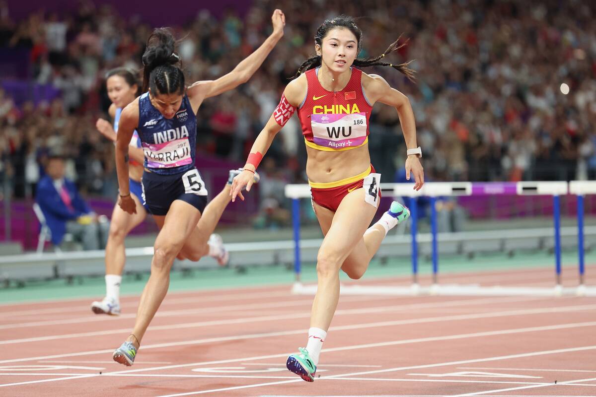 HANGZHOU, CHINA - OCTOBER 01: Wu Yanni (R) of China and Jyothi Yarraji of Team India competes in the Women's 100m Hurdles final athletics event during day 8 of the of the 19th Asian Games at Hangzhou Olympic Sports Centre on October 01, 2023 in Hangzhou, China.