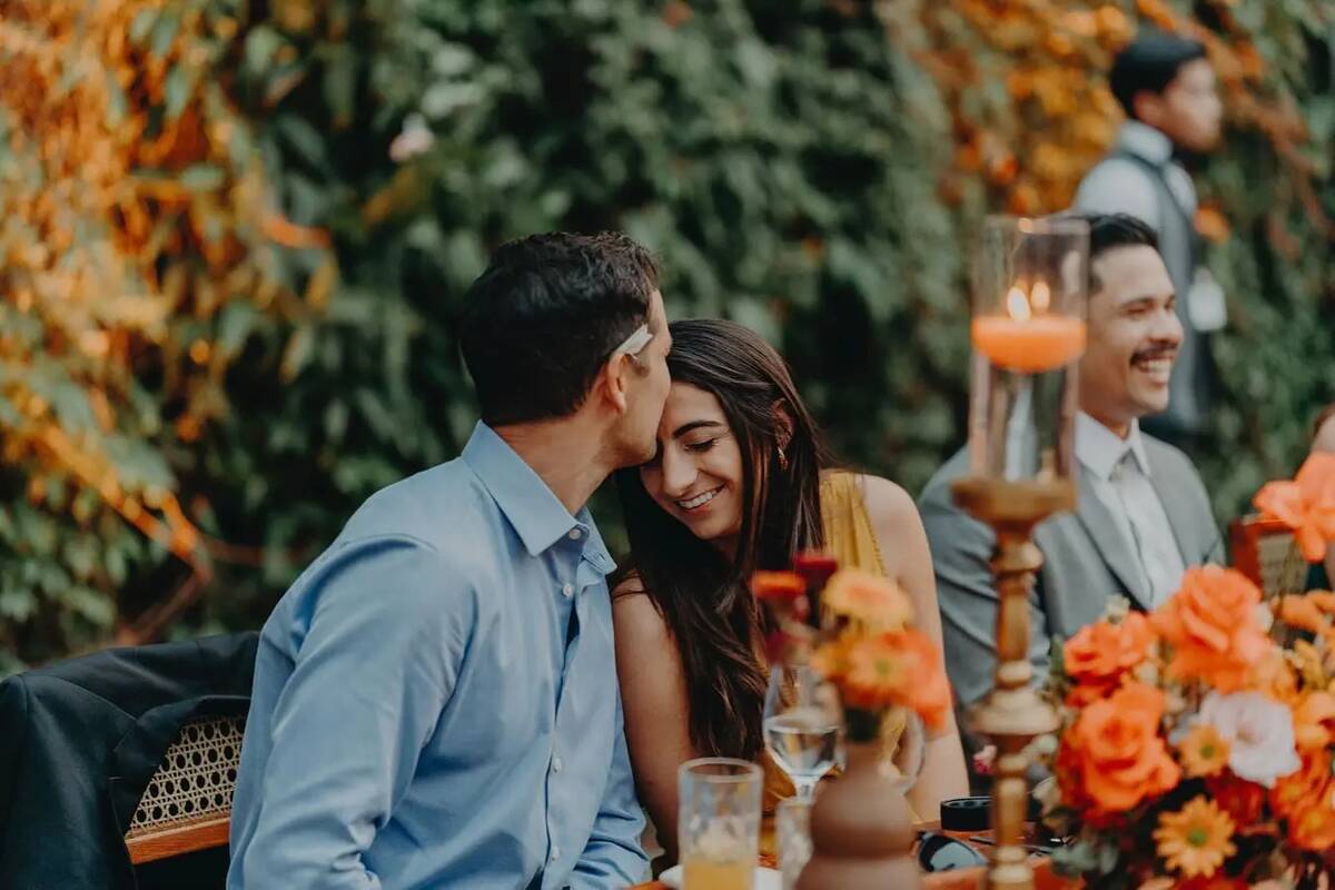 Cody Bryant and Haley Woloshen at a wedding, Cody kissing Haley's forehead.