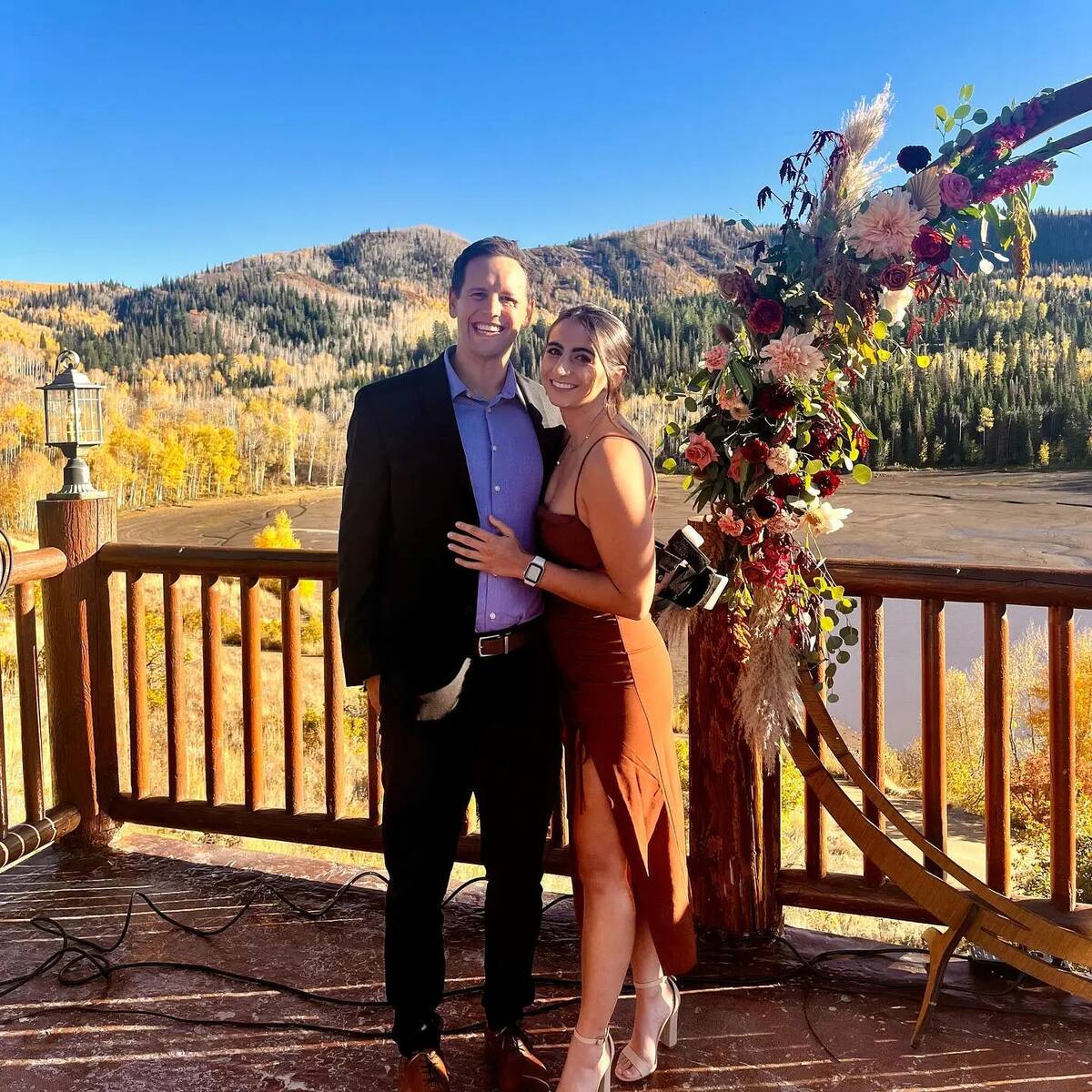 Cody Bryant and Haley Woloshen at a wedding together, standing side by side for a photo.