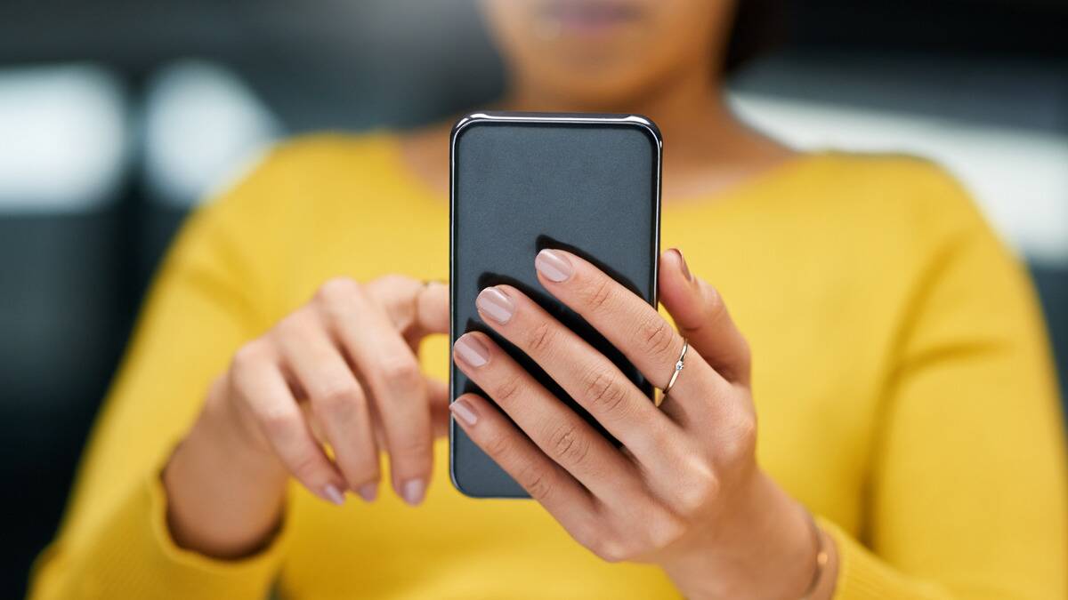 A close shot of a pair of hands holding up a smartphone.