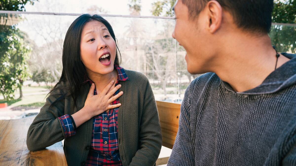 A woman speaking to her boyfriend, looking very passionate about what she's talking about.