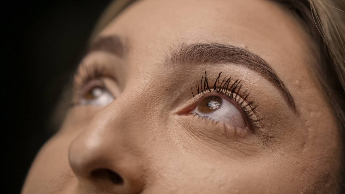 A close shot of a woman's eyes as they're turned upward.