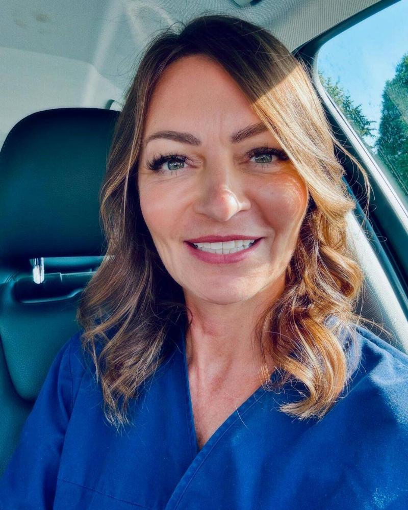 Dr. Bradford sitting in her car, smiling in a selfie.