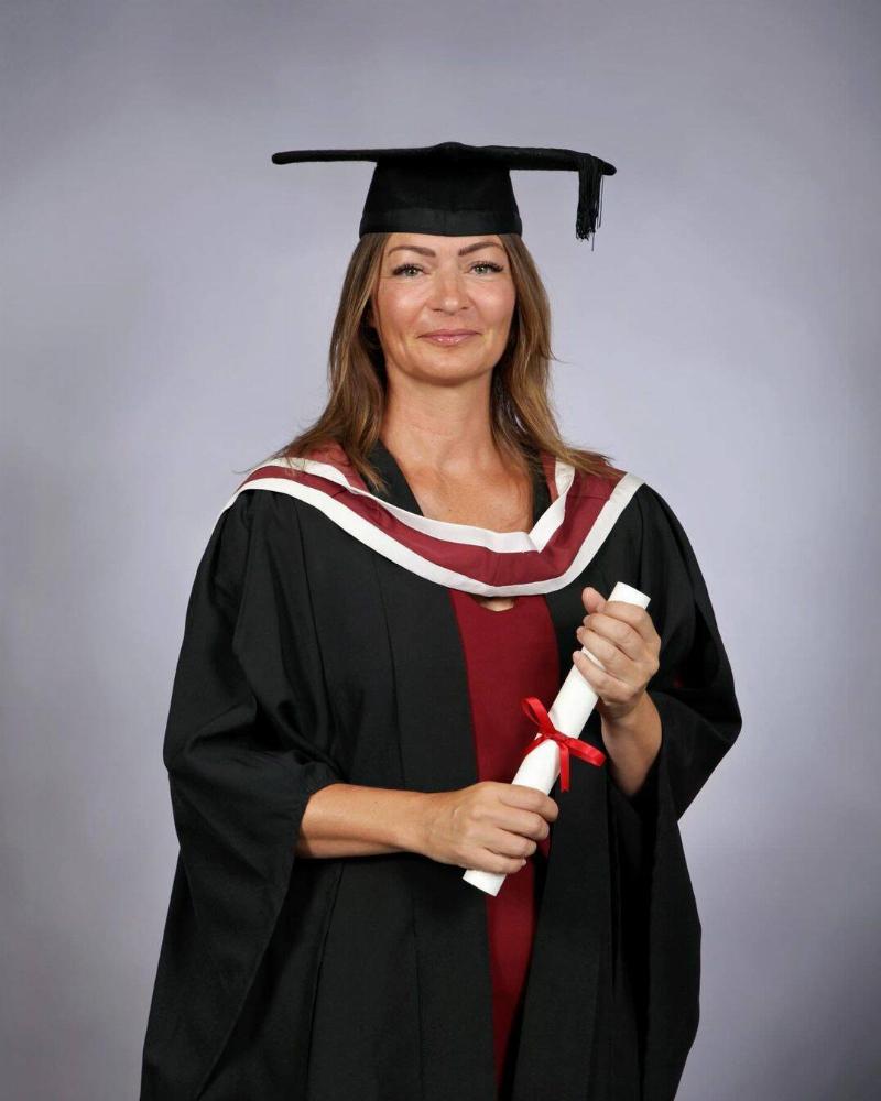 One of Dr. Bradford's graduation photos, holding her diploma.