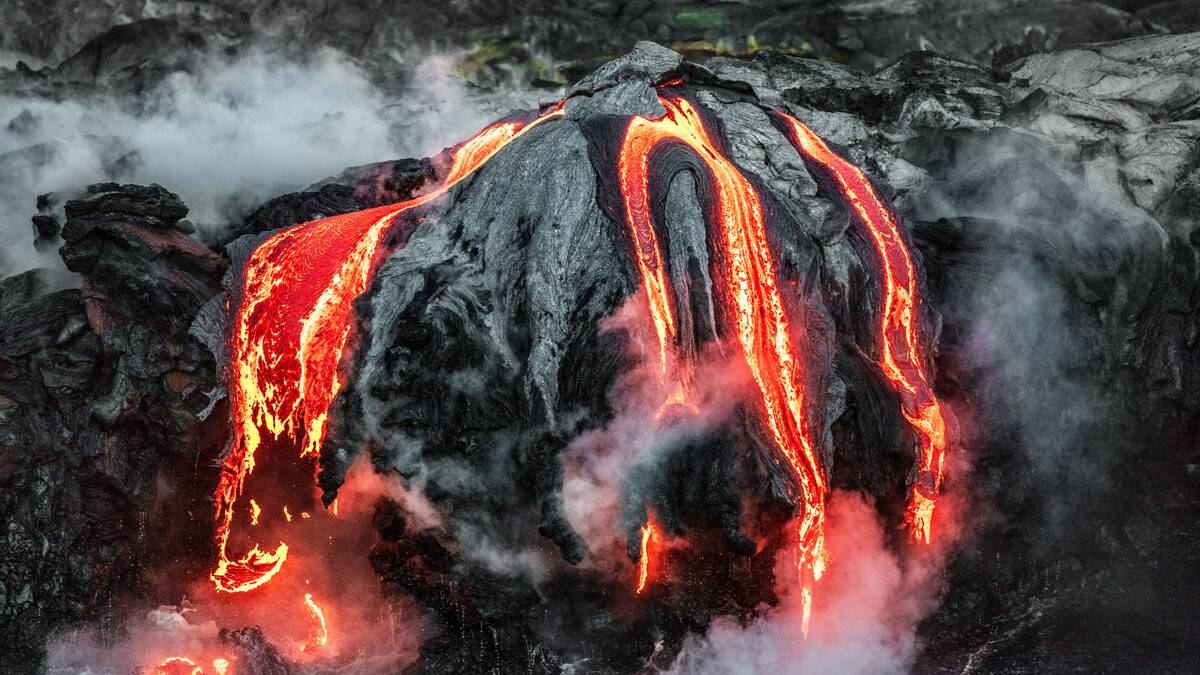 Molten rock that's oozing lava and smoke.