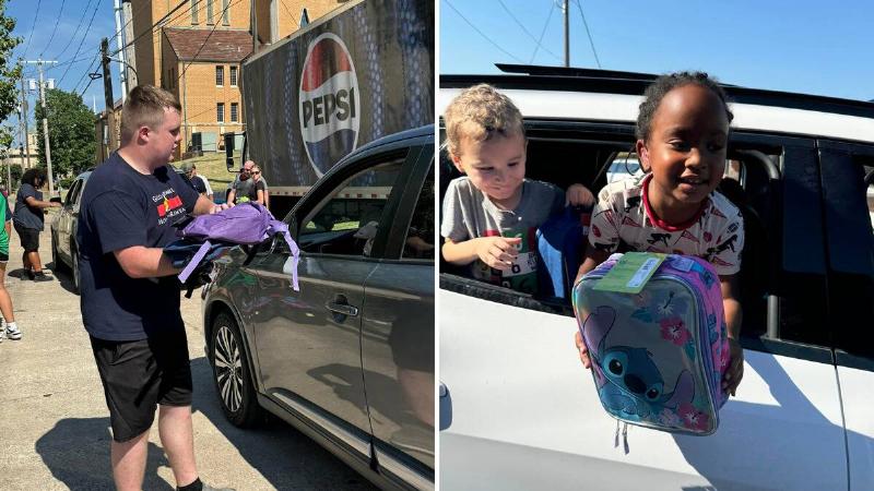 Reed handing someone a backpack through their open car window. | A girl leaning out the back window of the car she's riding in, showing off her new lunch box.