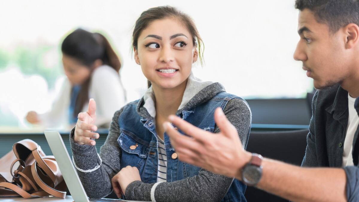 A woman looking at a man incredulously as she debates with him.