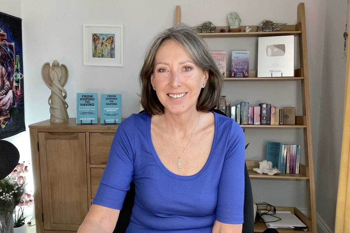 Poole at her desk, smiling for the camera.