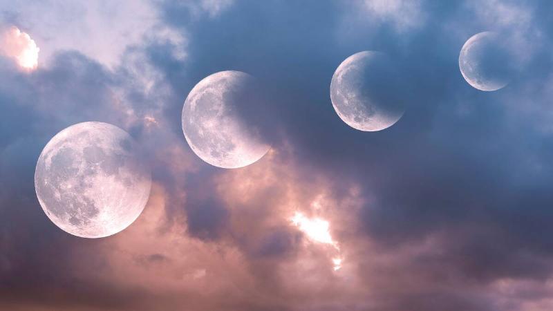 Four images of the moon all superimposed to show them at different spots in the sky and different states of eclipse.