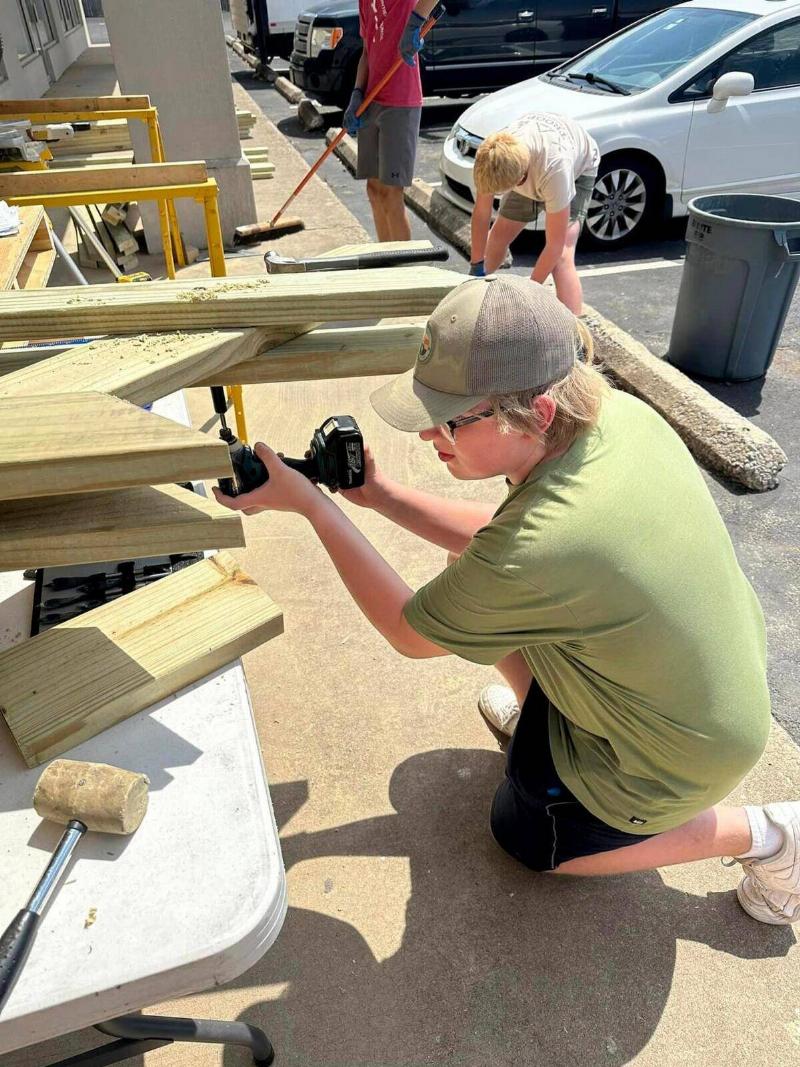 Starnes working on the tables outside with his team.