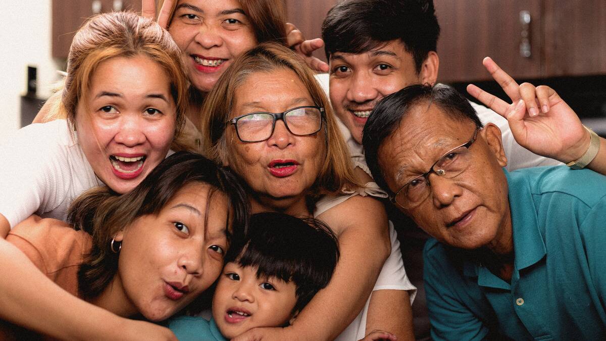 A few generations of a family all gathered together for a silly selfie.