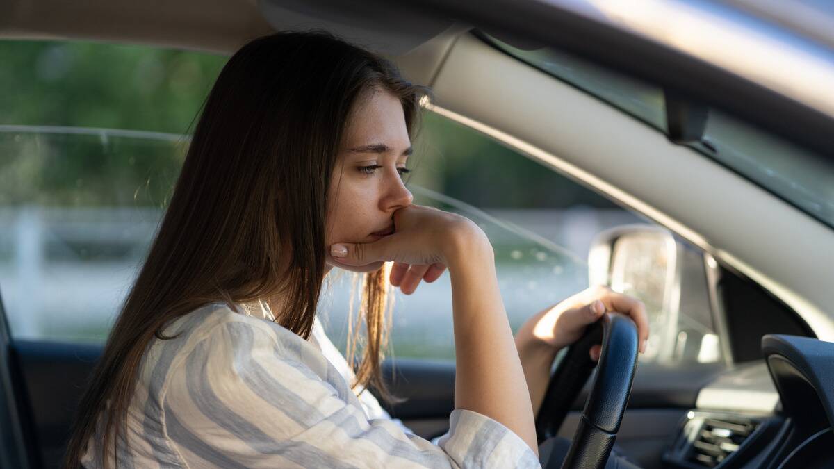 A woman looking sad, a hand on her chin.