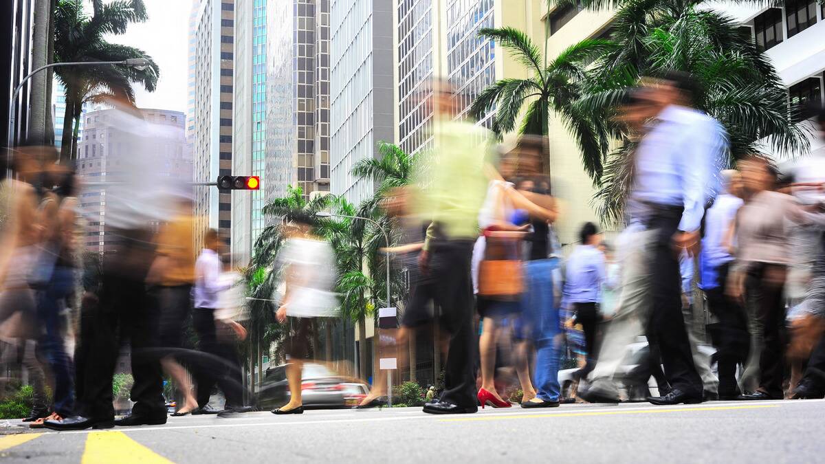 A busy intersection, blurred people walking by.